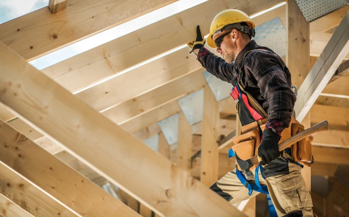 Man inspecting rafters in a new building.